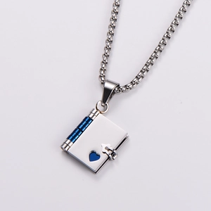 Macro shot of silver book locket pendant with blue spine and heart cutout details