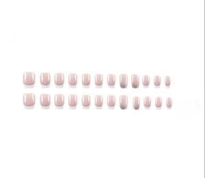 Flat lay of 24pcs nude French fake nails with white tips and silver glitter accents