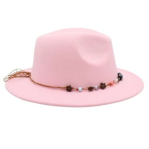 Detail of light pink wool fedora with woven rope band and bohemian bead decorations