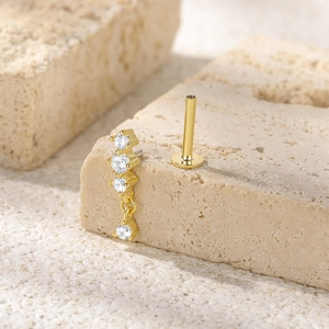 Macro view of gold S925 silver butterfly tassel earring with cubic zirconia and screw back