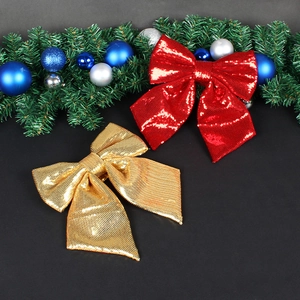 Glitter Christmas bows in red and gold on a festive background for tree decoration