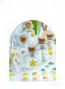 Close-up of 3D acrylic floral stickers applied on a glass jar for DIY decoration