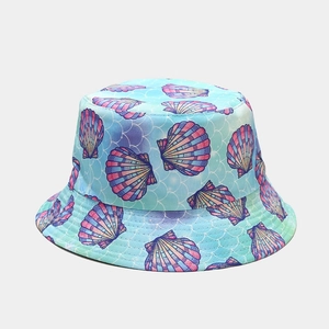 Detailed view of light blue bucket hat featuring colorful shell patterns and fish scale texture