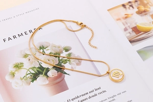Detail of gold snake chain with Virgo constellation pendant on an elegant magazine