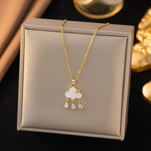 Close-up of golden cloud pendant necklace with zircon droplets in a jewelry box