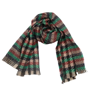 Close-up of red and green plaid scarf texture and frayed fringe tassels