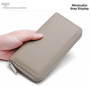 Detailed view of grey lychee grain leather wallet with silver metal zipper closure