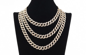 Close-up of luxury gold-plated Cuban link chain necklace with sparkling crystal inlay