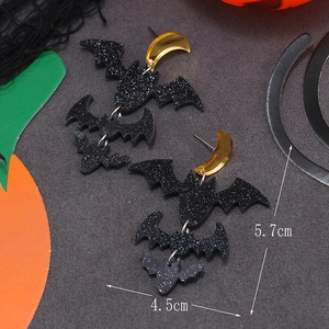 Detail view of black glitter bat earrings with gold moon and size dimensions