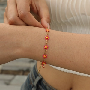 Women's gold O-chain bracelet with pink enamel flower charms and adjustable lobster clasp