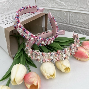 Elegant woven tweed headbands with pearl accents in pink and beige colors for women