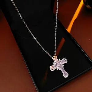 Sparkling pink zircon cross necklace with silver chain in a black jewelry box