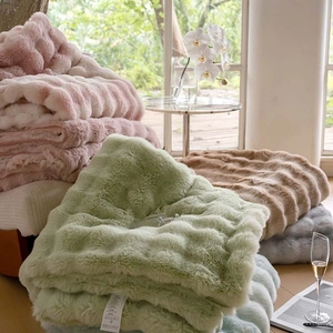 Detail of plush faux rabbit fur blanket with thick 3D wavy texture in multiple colors