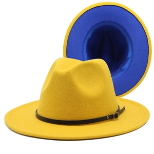 Detail of yellow wool fedora hat featuring blue contrast brim and black leather belt strap