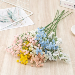 Close-up of colorful artificial baby's breath bouquets in pink, blue, and yellow hues