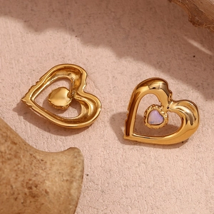 Detail of 18K gold plated double-layer heart earrings with white natural stone inlay
