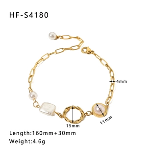 Detail view of gold stainless steel bracelet with white pearls and pink gemstone charms