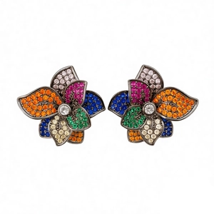 Vintage silver needle flower earrings with colorful zircon stones on a dark base