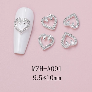 Macro shot of silver heart nail charms with rhinestones and bow design 9.5x10mm