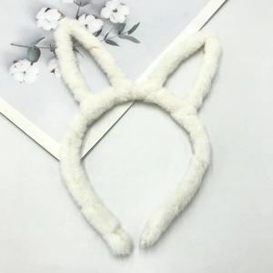 Close-up of soft white plush bunny ear headband with fluffy texture for hair styling