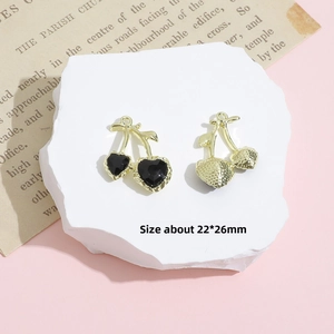 Detailed view of cherry-shaped gold pendants with black heart stone, size 22x26mm
