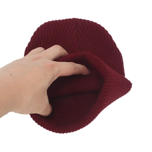 Burgundy ribbed knit beanie hat for winter warmth shown with elastic stretch test
