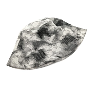 Detail shot of tie-dye bucket hat showing grey abstract jacquard texture and fine stitching