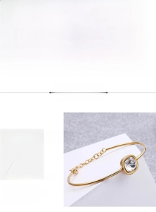 Detail showing 316L stainless steel gold bracelet with square cubic zirconia and clasp