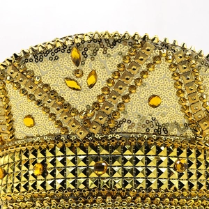 Macro detail of gold sequins and metallic rivets on the luxury bride party captain hat