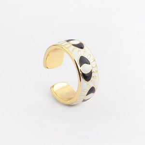 Detailed macro view of gold-plated Evil Eye open ring with black and white enamel drip