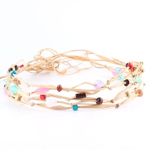Detail of bohemian raffia headband with colorful beads and woven retro braided cord