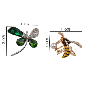 Detailed view of crystal dragonfly brooch and bee pin with pearl and enamel finish