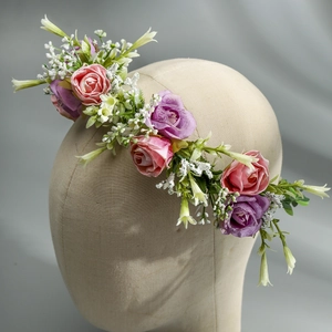Detail of pink and purple silk roses on a floral headband for photography and events