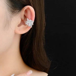 Detailed close-up of a silver flower star ear cuff with sparkling cubic zirconia stones