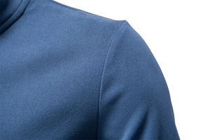 Macro detail of navy blue athletic fabric showing high-density weave and shoulder stitching