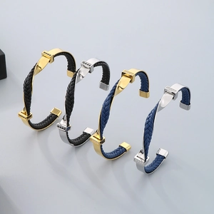Detail of twisted titanium steel C-shape bracelets with woven leather in multiple colors