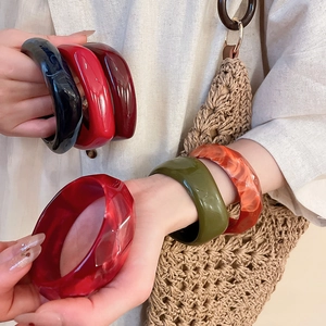 Macro shot of colorful faceted acrylic resin bangles with glossy marble textures