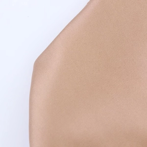 Close-up of brown satin fabric showing fine texture and smooth weave on white background