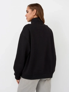 Detailed side-back view of thick black oversized sweatshirt with drop shoulder cut