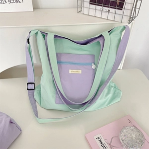 Detail of internal zipper pocket and brand logo inside the green canvas tote bag