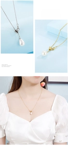 Detail of drop-shaped pearl Y-necklace with gold and silver chain on model