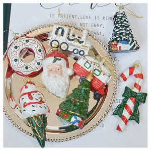 Assorted colorful Christmas tree ornaments in a silver tray for holiday decoration