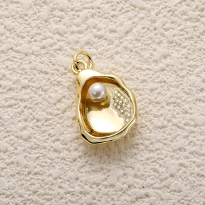 Macro detail of 14k gold plated seashell pendant with pearl for DIY jewelry making