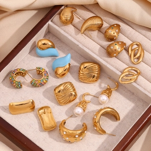 Detailed top view of 18K gold plated geometric earrings in a wooden jewelry box