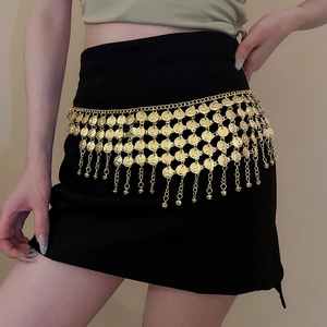 Detail view of bohemian golden coin waist chain with tassel charms on a black skirt