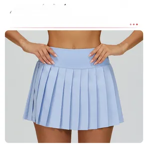 Detail of light blue high-waisted pleated tennis skirt with elastic athletic fabric
