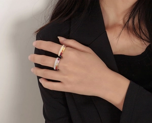 Close-up of stacked S925 sterling silver rings with rainbow gradient stones and cubic zirconia