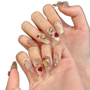 Champagne cat-eye almond press-on nails with heart rhinestones and gold star studs