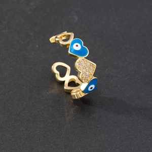 Detailed close-up of gold evil eye heart ring with blue enamel and zircon inlay