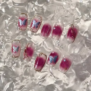 Detailed view of plum gradient press-on nails with holographic butterfly and pearl art